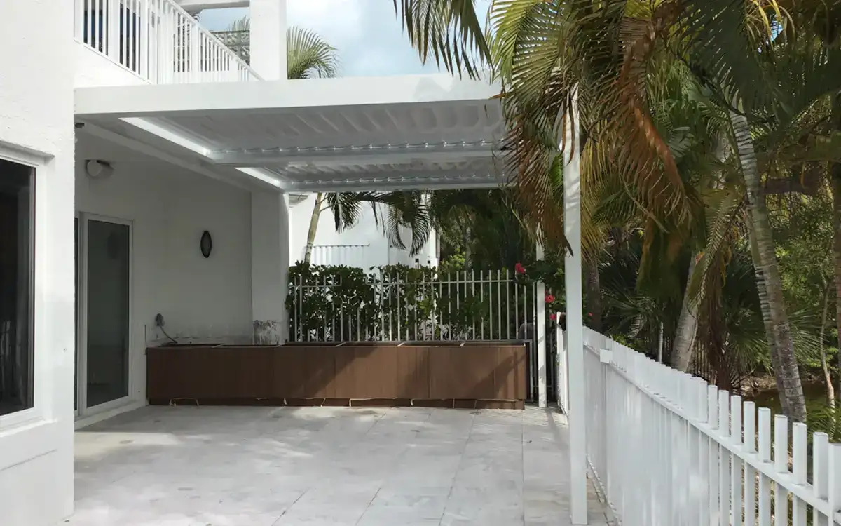White louvered roof over a marble patio