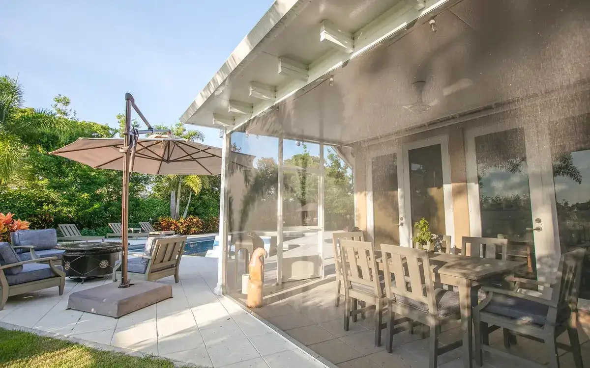 Screened patio with clear panels by the pool
